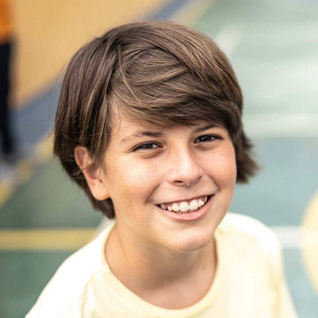 Portrait of a boy at a sports court